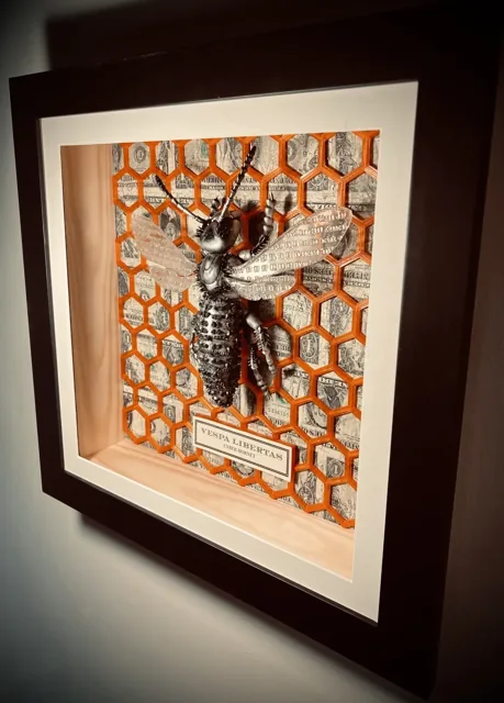 An angled view of the framed sculpture.