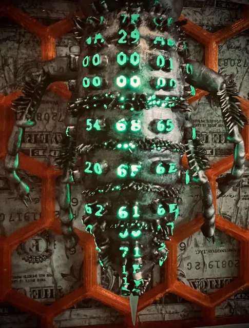 Glowing green characters across the hornet body.
