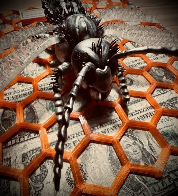 Sculpted head, antennae and wings against the orange honeycomb.